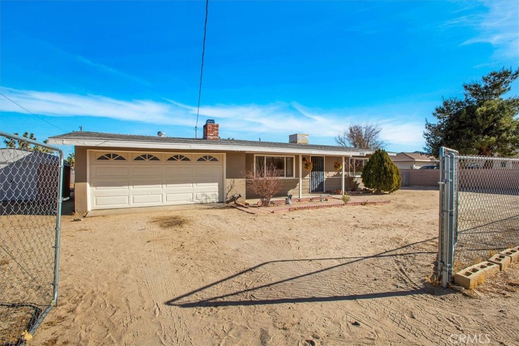 7175 Scarvan Road Yucca Valley, CA 92284 - Photo 1 of 1 a view of a house with wooden fence