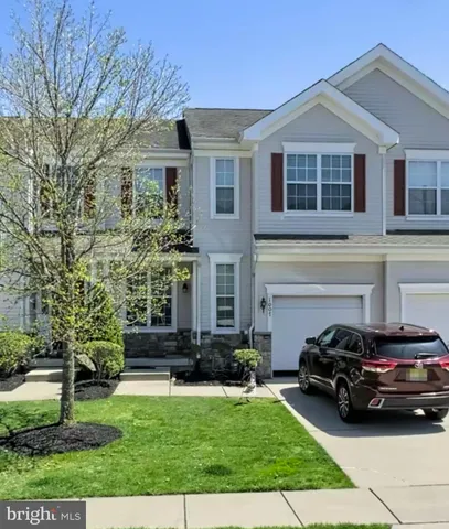 a view of a car parked in front of a brick house