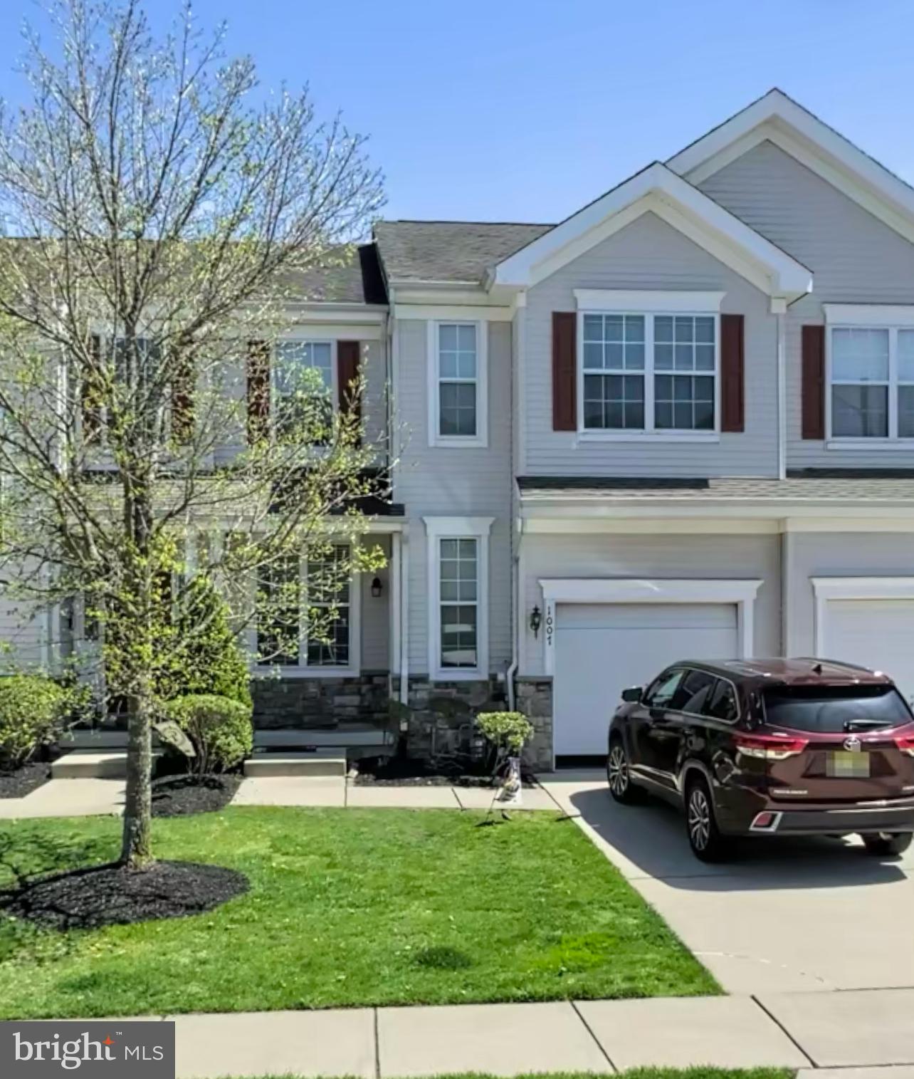 a view of a car parked in front of a brick house