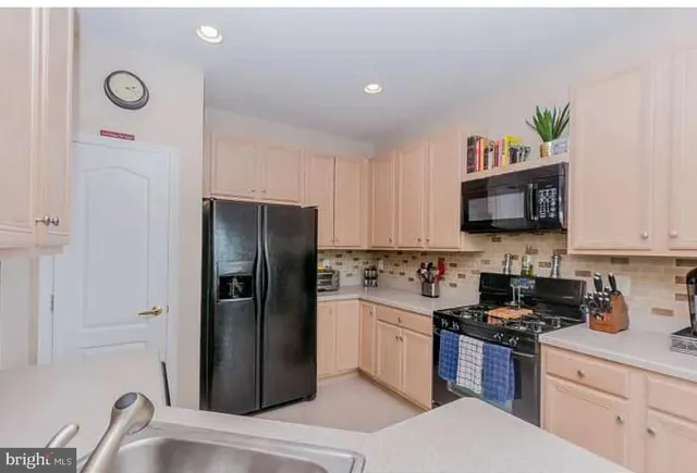 a kitchen with a refrigerator and a sink