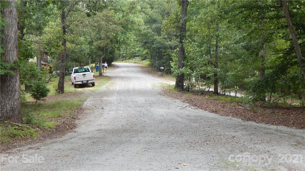 342 Sasafras Ridge, Unit 100 Rutherfordton, NC 28139 - Photo 4 of 4 a view of a dirt road with trees in the background