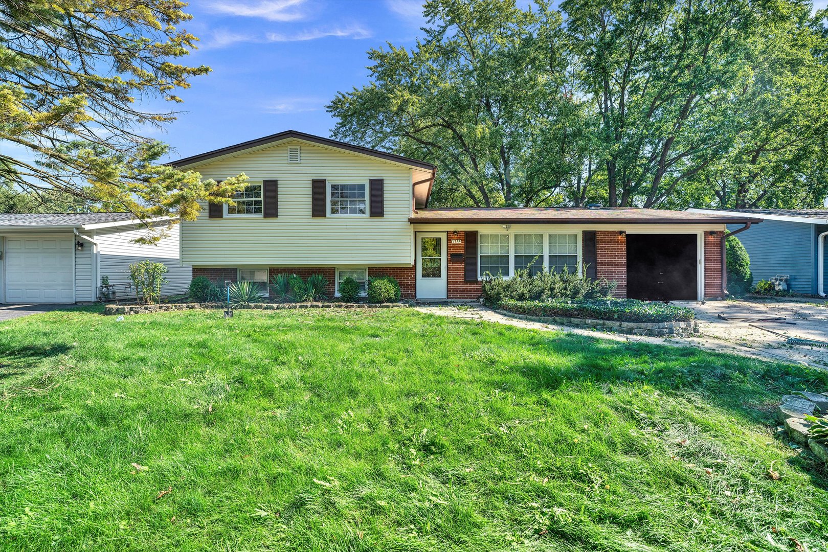 7133 Edgebrook Lane Hanover Park, IL 60133 - Photo 1 of 26 a view of a house with a yard and a garden