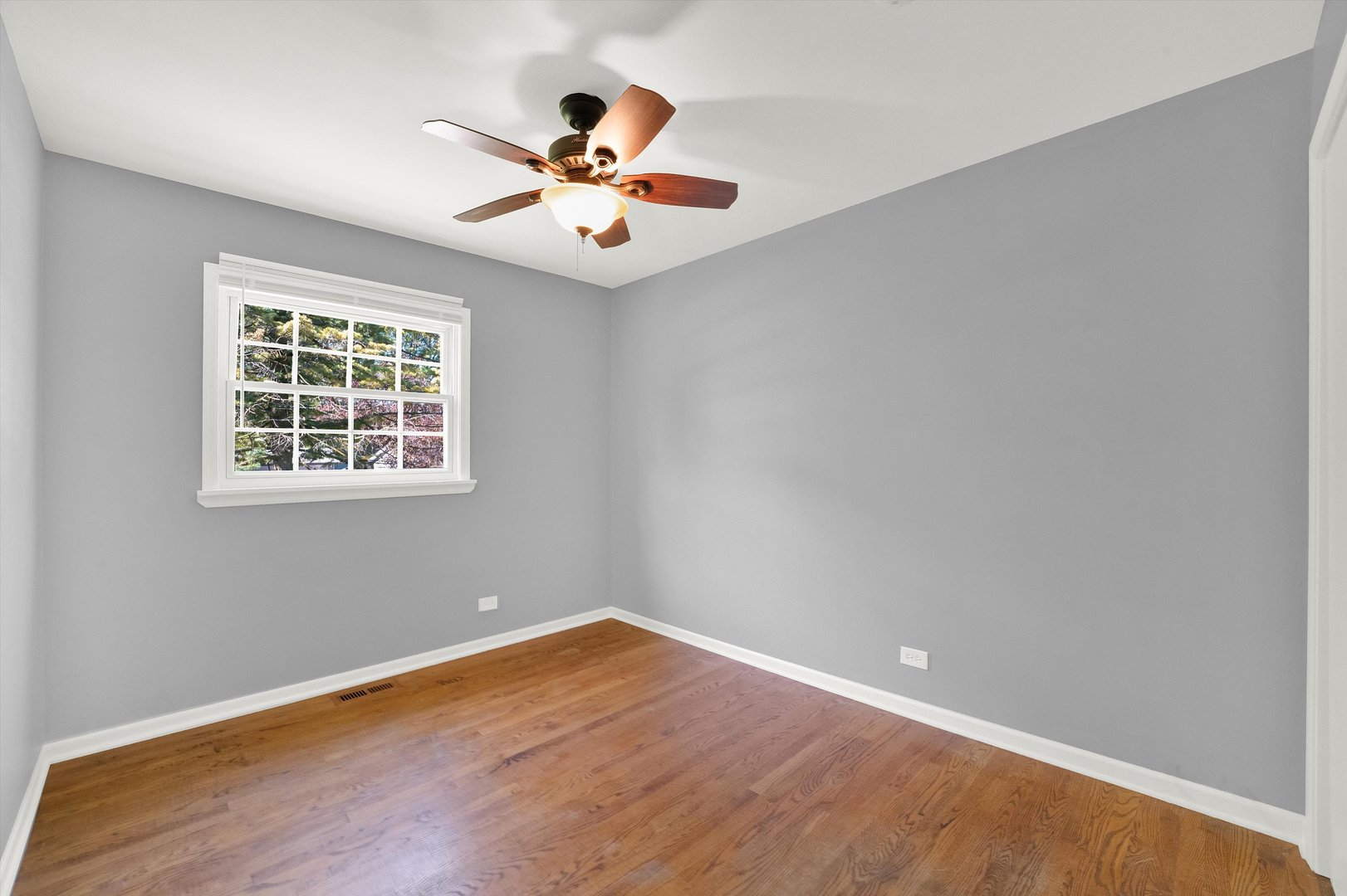 7133 Edgebrook Lane Hanover Park, IL 60133 - Photo 15 of 26 a view of empty room with wooden floor and fan