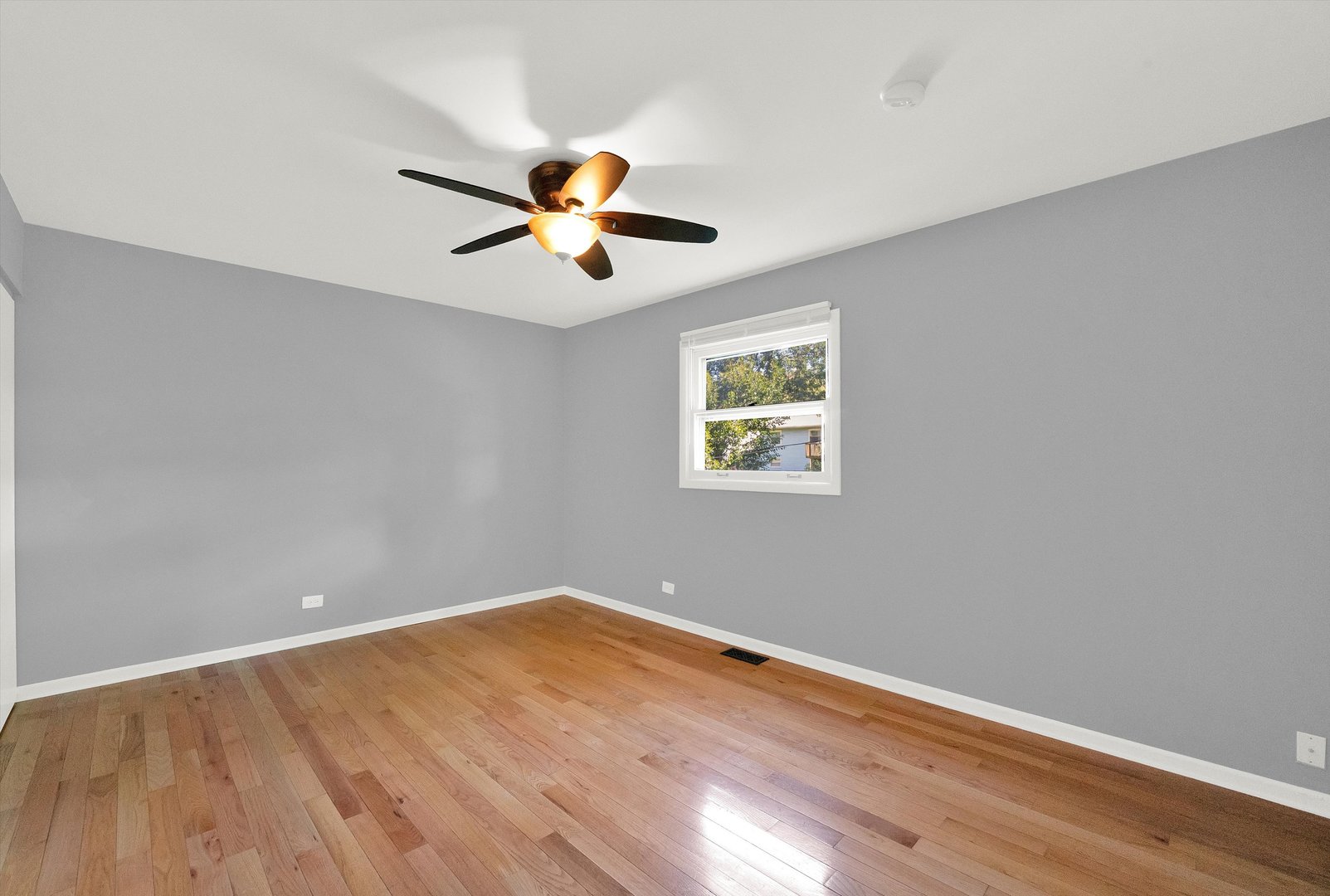 7133 Edgebrook Lane Hanover Park, IL 60133 - Photo 17 of 26 wooden floor in an empty room with a window
