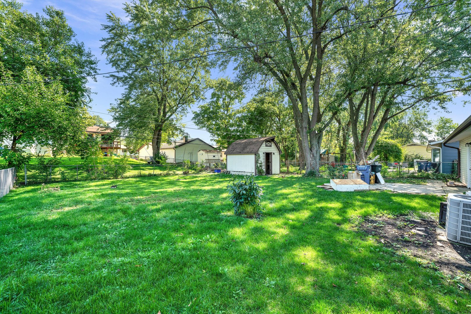7133 Edgebrook Lane Hanover Park, IL 60133 - Photo 25 of 26 a view of a backyard with large trees