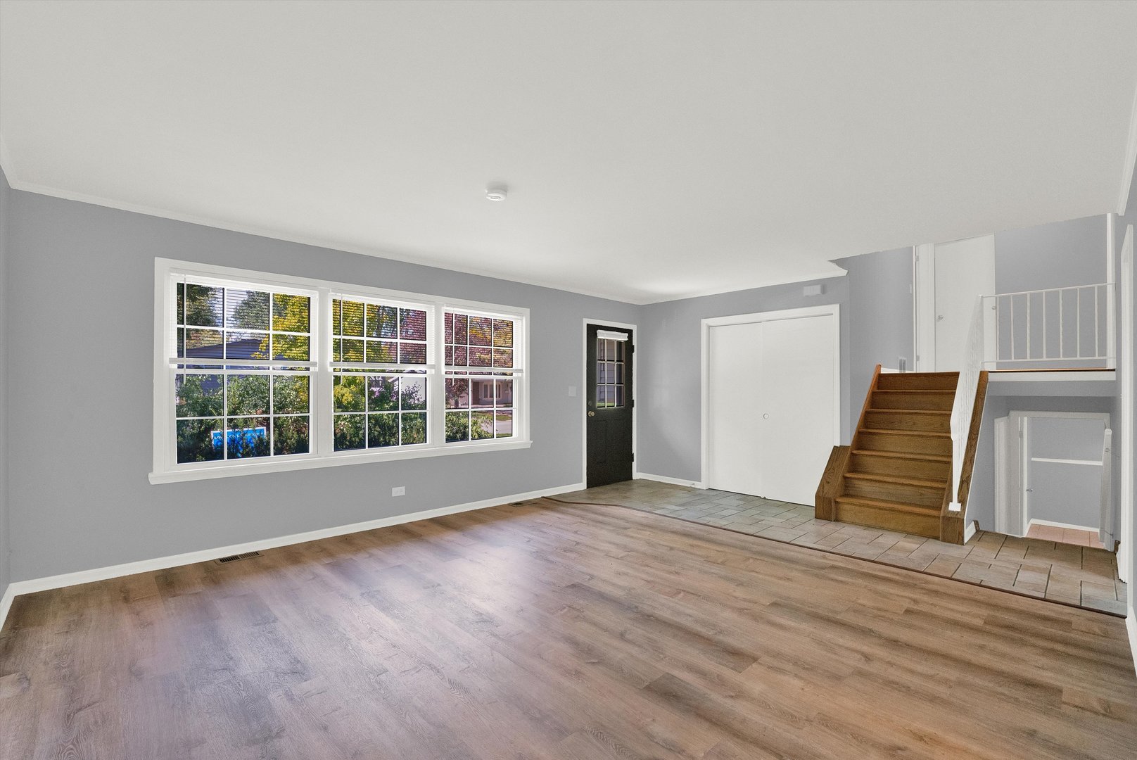 7133 Edgebrook Lane Hanover Park, IL 60133 - Photo 3 of 26 a view of an empty room with wooden floor and windows