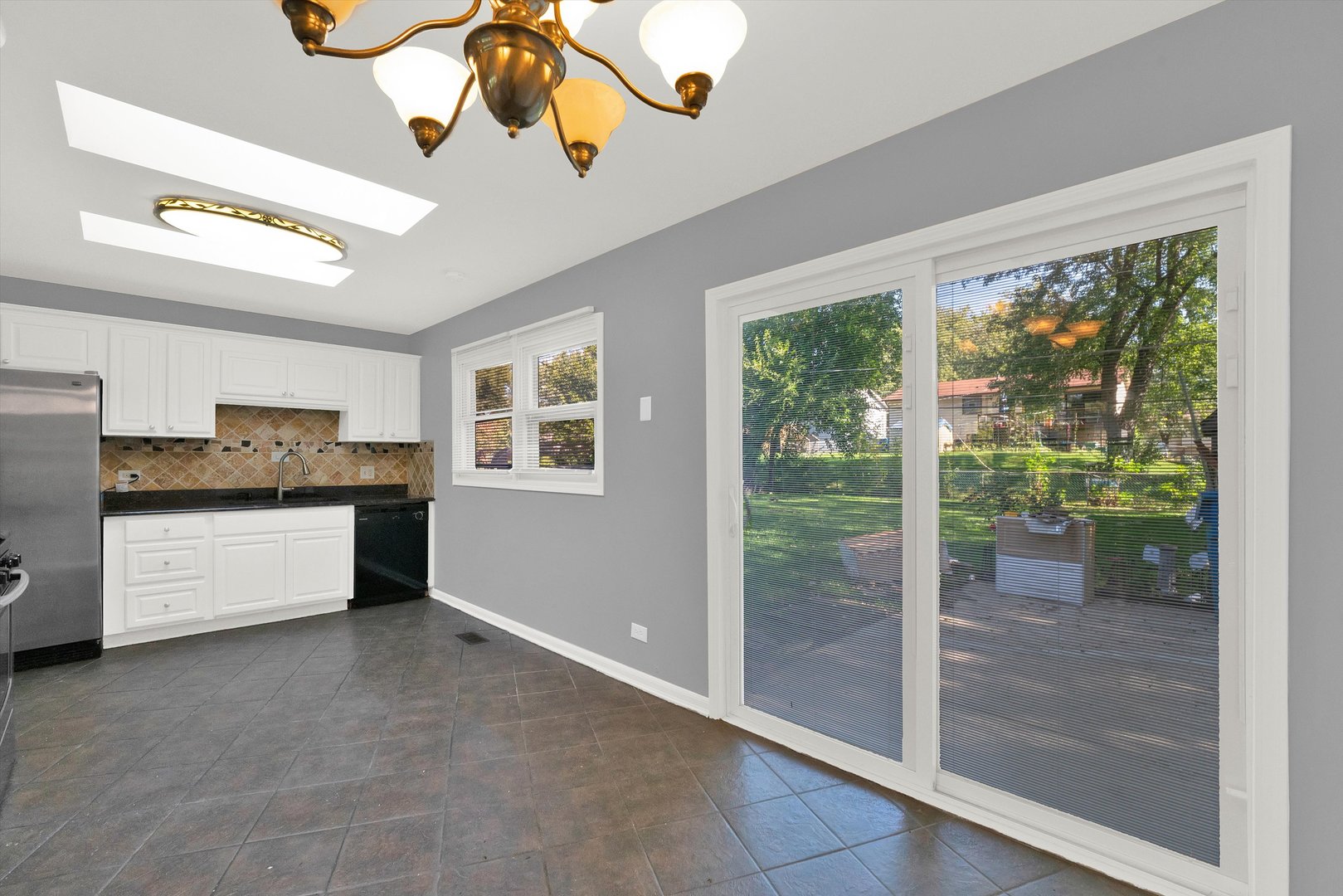 7133 Edgebrook Lane Hanover Park, IL 60133 - Photo 6 of 26 a kitchen with stainless steel appliances granite countertop a refrigerator a sink and a stove