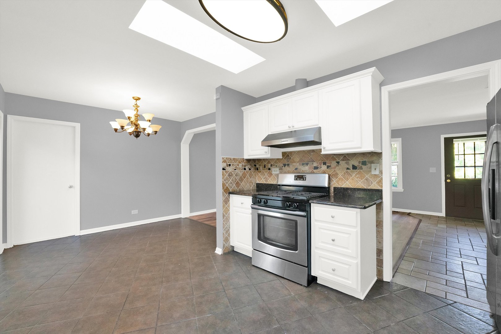 7133 Edgebrook Lane Hanover Park, IL 60133 - Photo 7 of 26 a kitchen with granite countertop a sink cabinets and stainless steel appliances