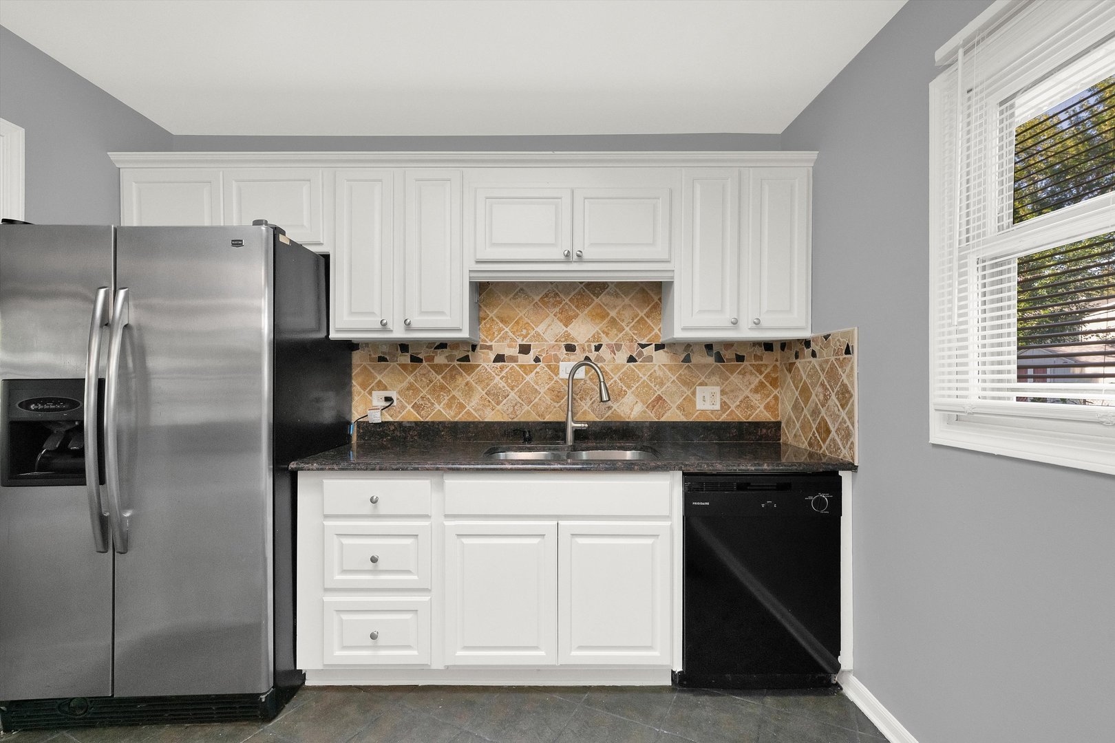 7133 Edgebrook Lane Hanover Park, IL 60133 - Photo 9 of 26 a kitchen with granite countertop white cabinets and stainless steel appliances