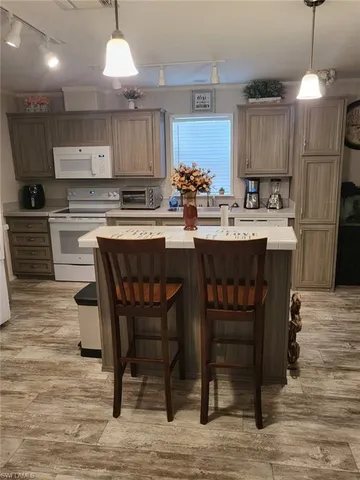 a kitchen with a table chairs stove and cabinets