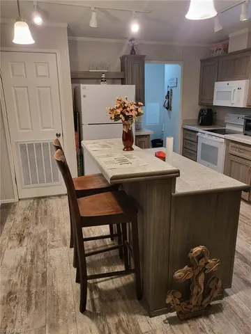 a kitchen with kitchen island a stove and a refrigerator
