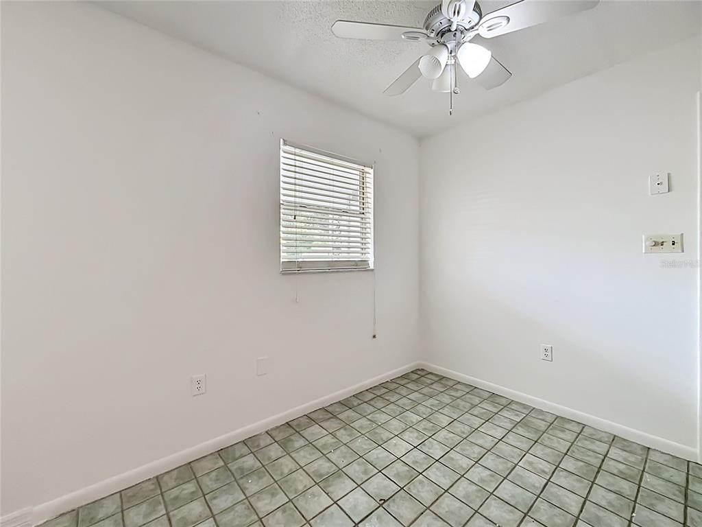 3 Bahia Pl Loop Ocala, FL 34472 - Photo 23 of 31 an empty room with a chandelier fan