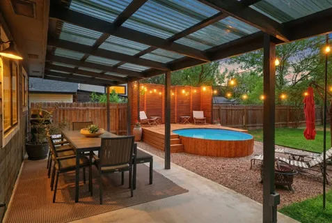 a view of a patio with a table chairs and a backyard