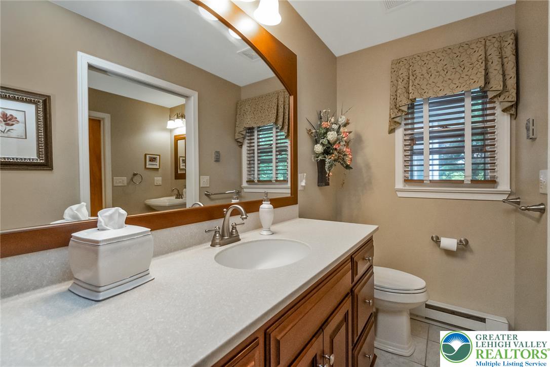 1328 Russett Road Allentown, PA 18104 - Photo 33 of 46 A well-appointed bathroom features a single vanity and a window with blinds for natural illumination.