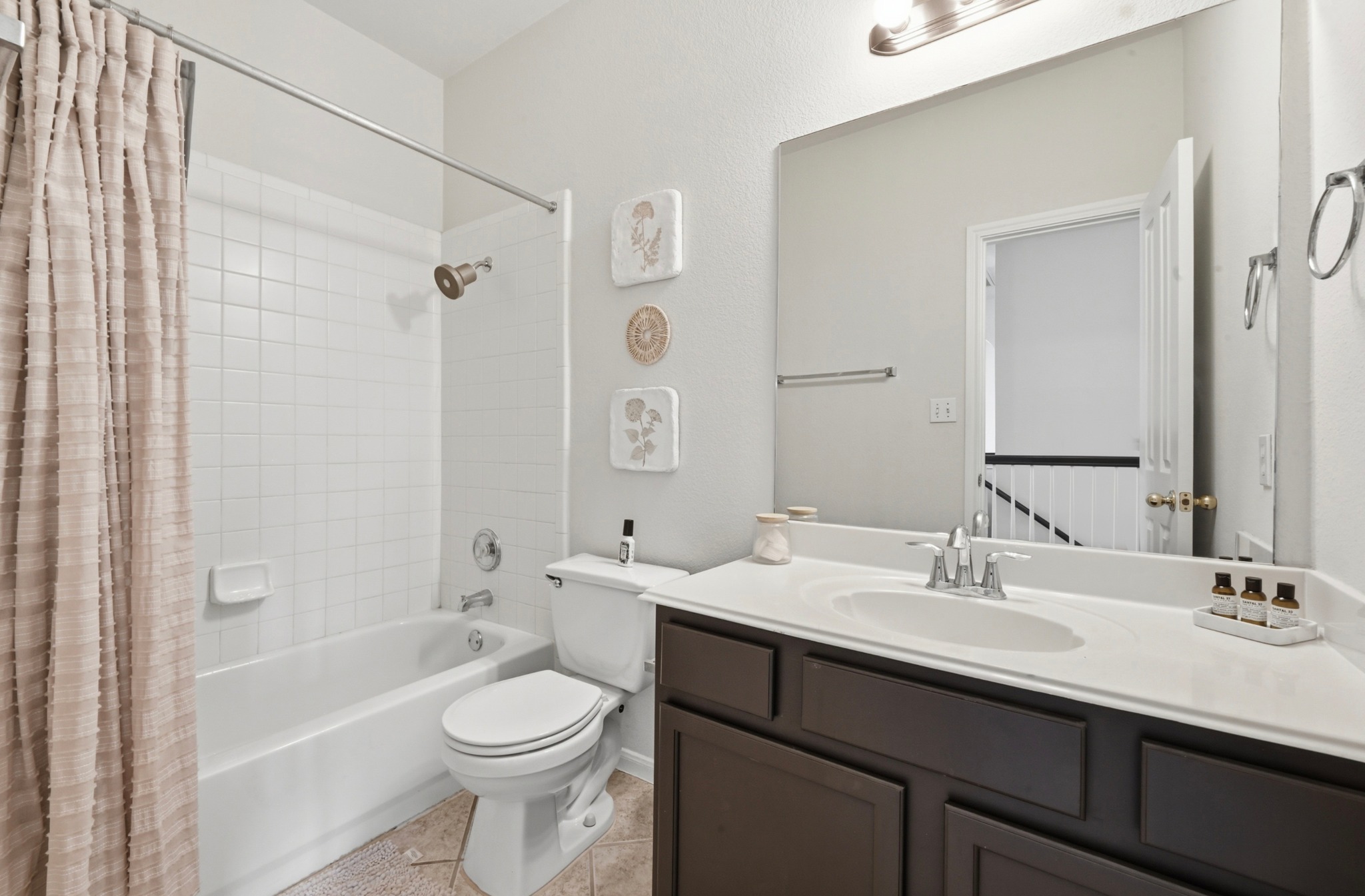 5888 Fergus Kyle, TX 78640 - Photo 25 of 40 A well-appointed bath features a tub with shower and a vanity with ample counter space.