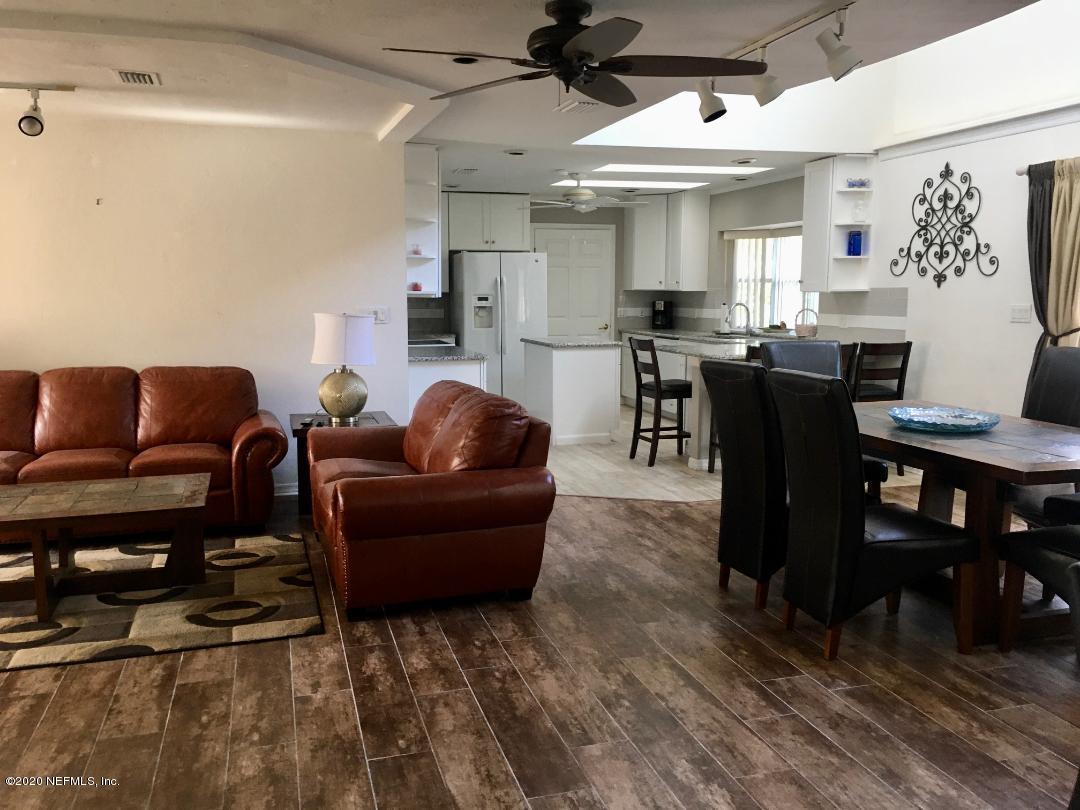22 Bermuda Run Way St. Augustine, FL 32080 - Photo 11 of 30 a living room with furniture and a dining table with kitchen appliances