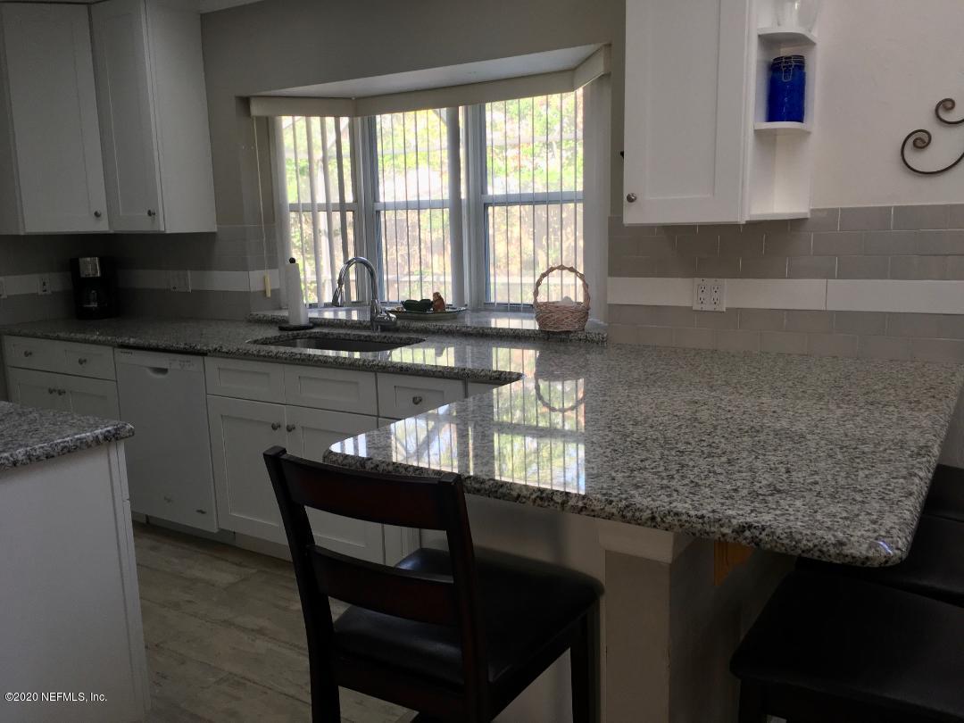 22 Bermuda Run Way St. Augustine, FL 32080 - Photo 17 of 30 a kitchen with granite countertop a sink window and cabinets
