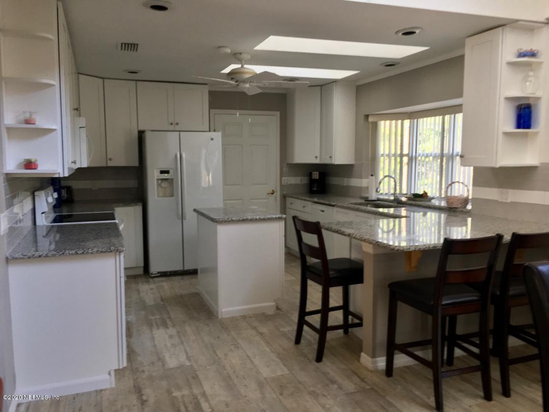 22 Bermuda Run Way St. Augustine, FL 32080 - Photo 18 of 30 a kitchen with stainless steel appliances a dining table chairs and a refrigerator