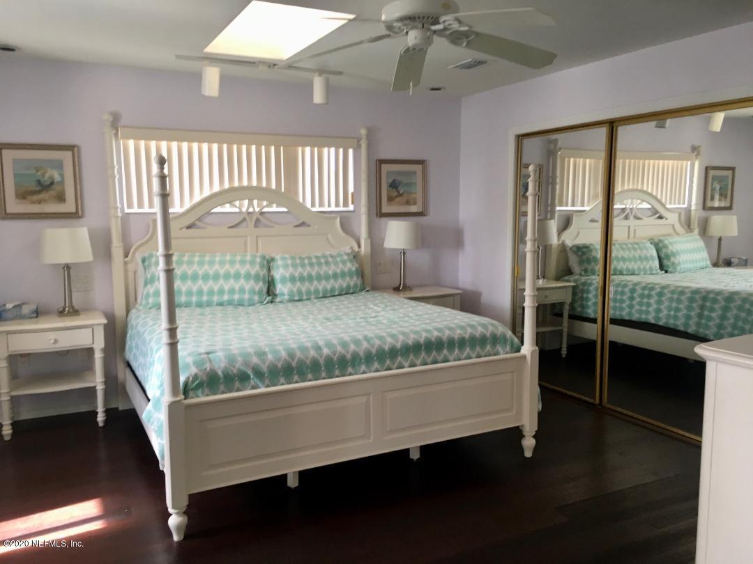 22 Bermuda Run Way St. Augustine, FL 32080 - Photo 20 of 30 a bedroom with a large bed and a chandelier fan
