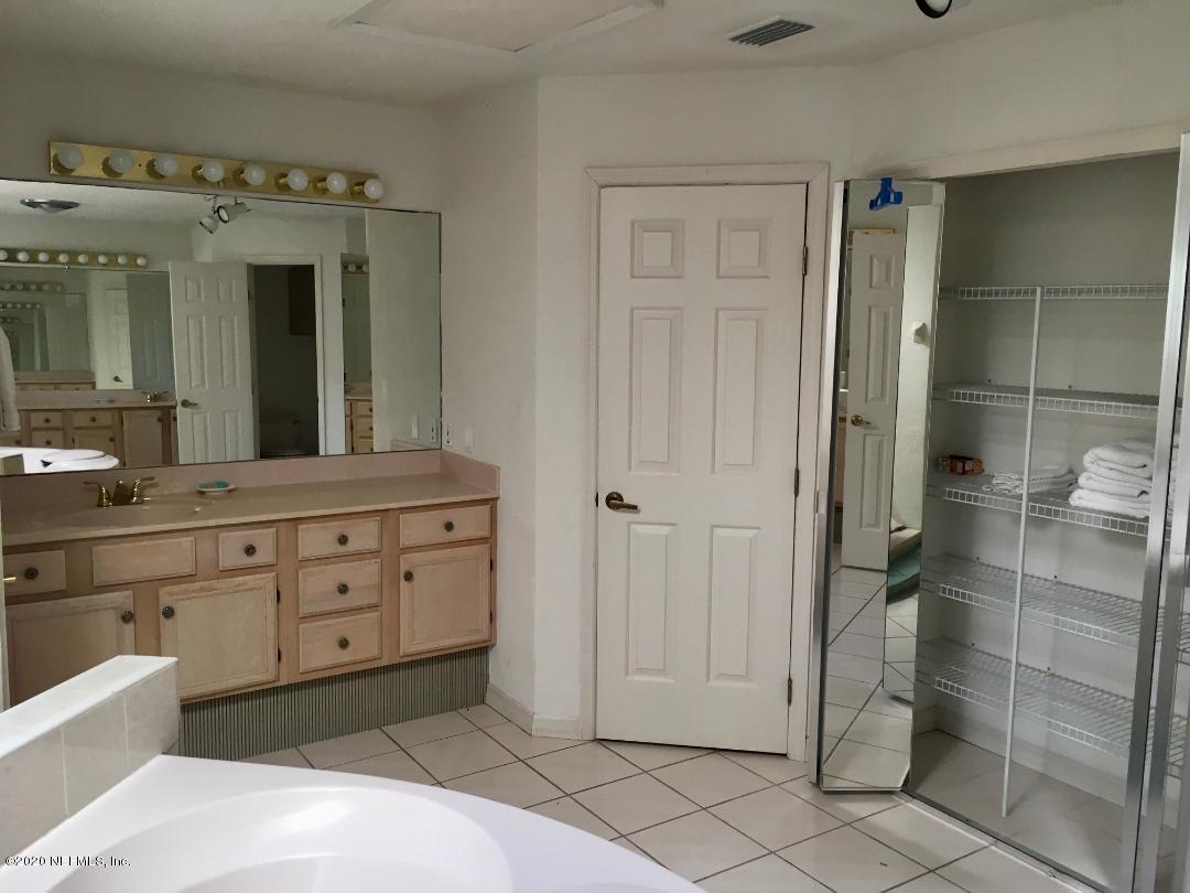 22 Bermuda Run Way St. Augustine, FL 32080 - Photo 25 of 30 a spacious bathroom with a double vanity sink and mirror