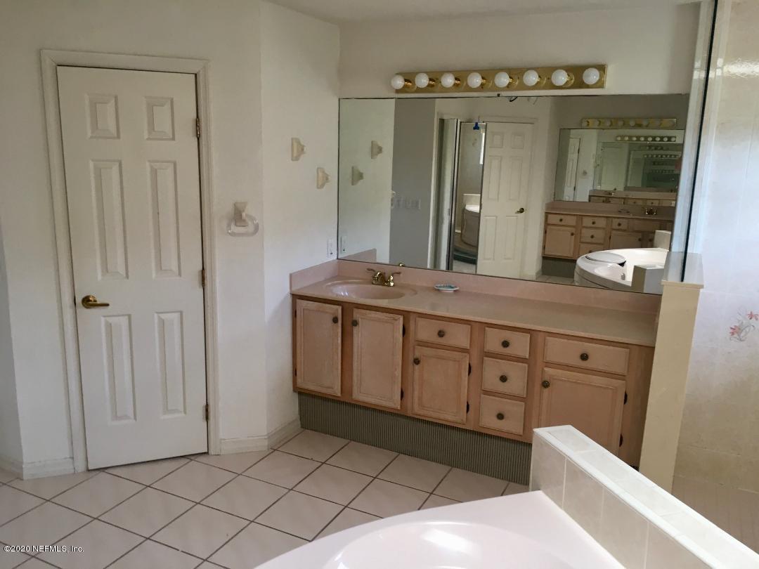 22 Bermuda Run Way St. Augustine, FL 32080 - Photo 27 of 30 a spacious bathroom with a granite countertop sink mirror and