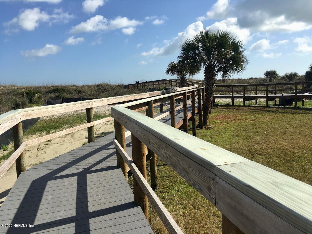 22 Bermuda Run Way St. Augustine, FL 32080 - Photo 6 of 30 a view of roof deck with two large trees and wooden fence