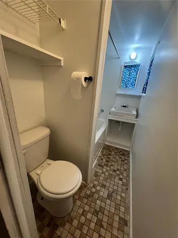 a bathroom with a toilet and a shower