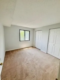 an empty room with a empty space and windows