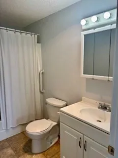 a white toilet sitting next to a bathroom sink