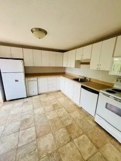 a kitchen with a sink cabinets and appliances