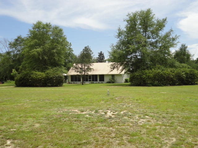 6404 Old River Road Baker, FL 32531 - Photo 1 of 28 a view of a big yard with a small yard and wooden fence