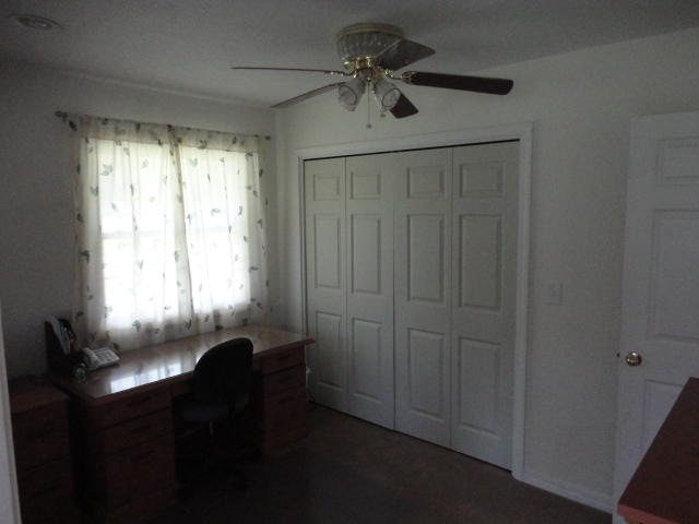 6404 Old River Road Baker, FL 32531 - Photo 19 of 28 a view of a workspace with furniture and a window