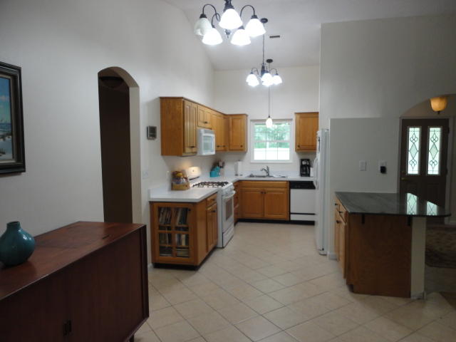 6404 Old River Road Baker, FL 32531 - Photo 21 of 28 a kitchen with stainless steel appliances a sink stove and refrigerator