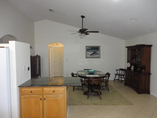 6404 Old River Road Baker, FL 32531 - Photo 24 of 28 a view of a kitchen area with furniture and refrigerator