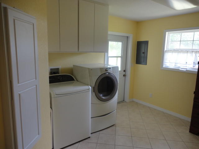 6404 Old River Road Baker, FL 32531 - Photo 25 of 28 a utility room with dryer and washer