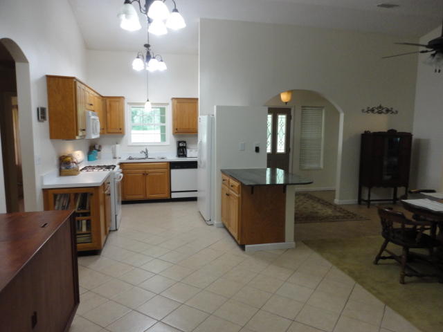 6404 Old River Road Baker, FL 32531 - Photo 26 of 28 a large kitchen with kitchen island a sink a stove a dining table and chairs