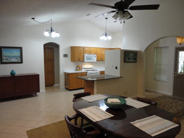 6404 Old River Road Baker, FL 32531 - Photo 28 of 28 a kitchen with a sink dining table and chairs