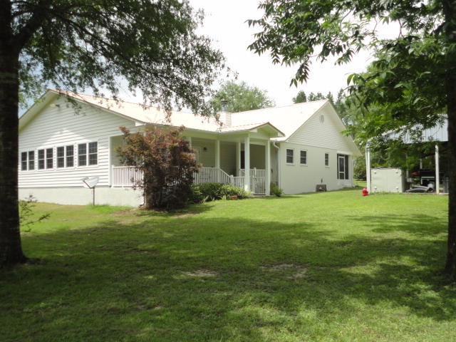 6404 Old River Road Baker, FL 32531 - Photo 7 of 28 a front view of a house with a garden