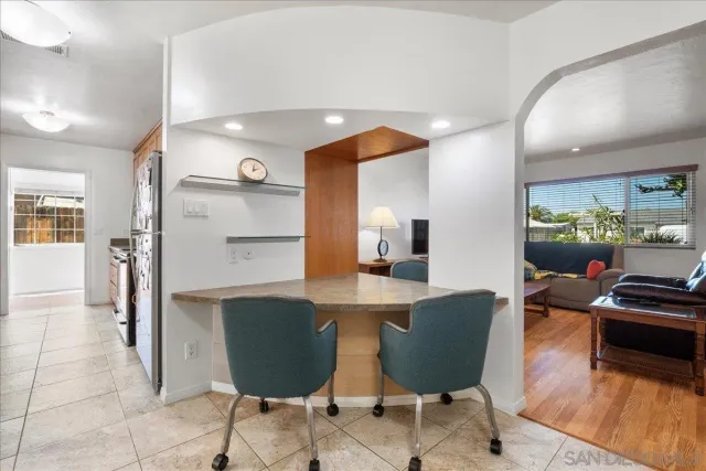 a living room with stainless steel appliances kitchen island granite countertop furniture and a view of kitchen