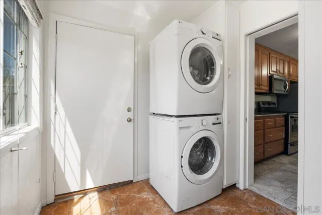 a view of a bedroom with washer and dryer