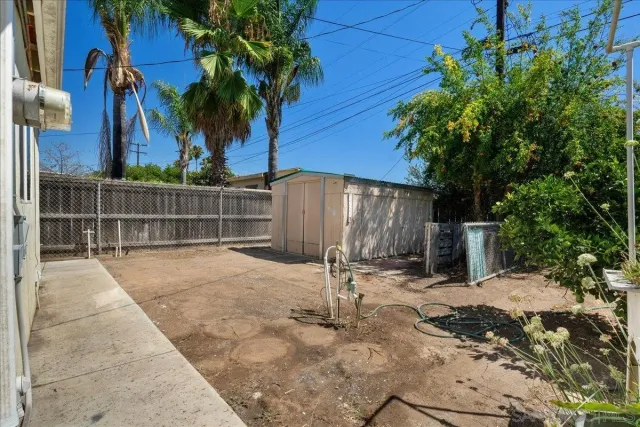 a front view of a house with a yard and potted plants