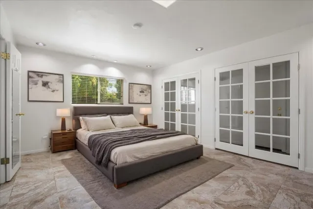 a bedroom with a large bed and a large window