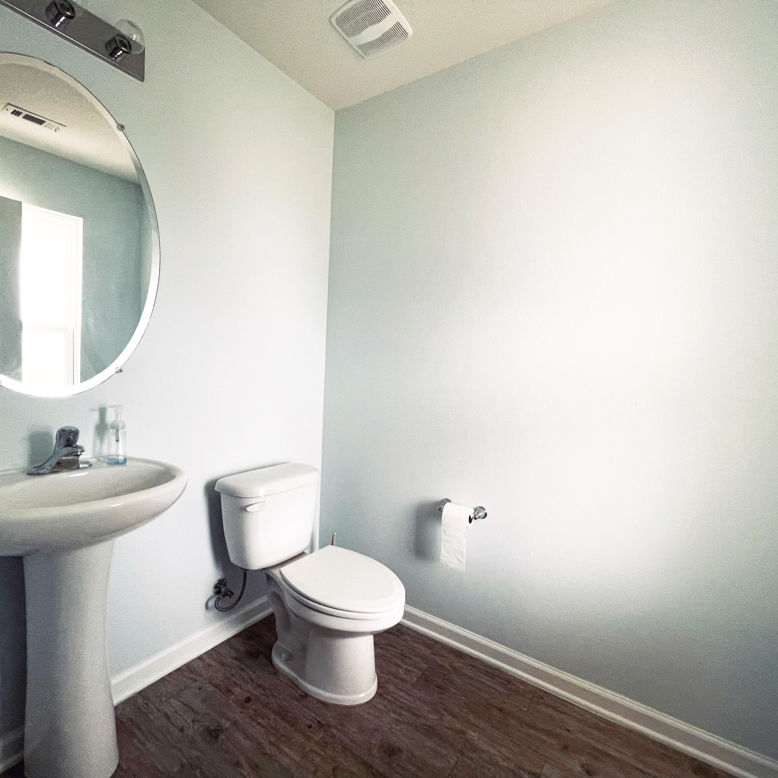 745 Widgeon Way Crestview, FL 32539 - Photo 13 of 17 a white toilet sitting next to a bathroom sink