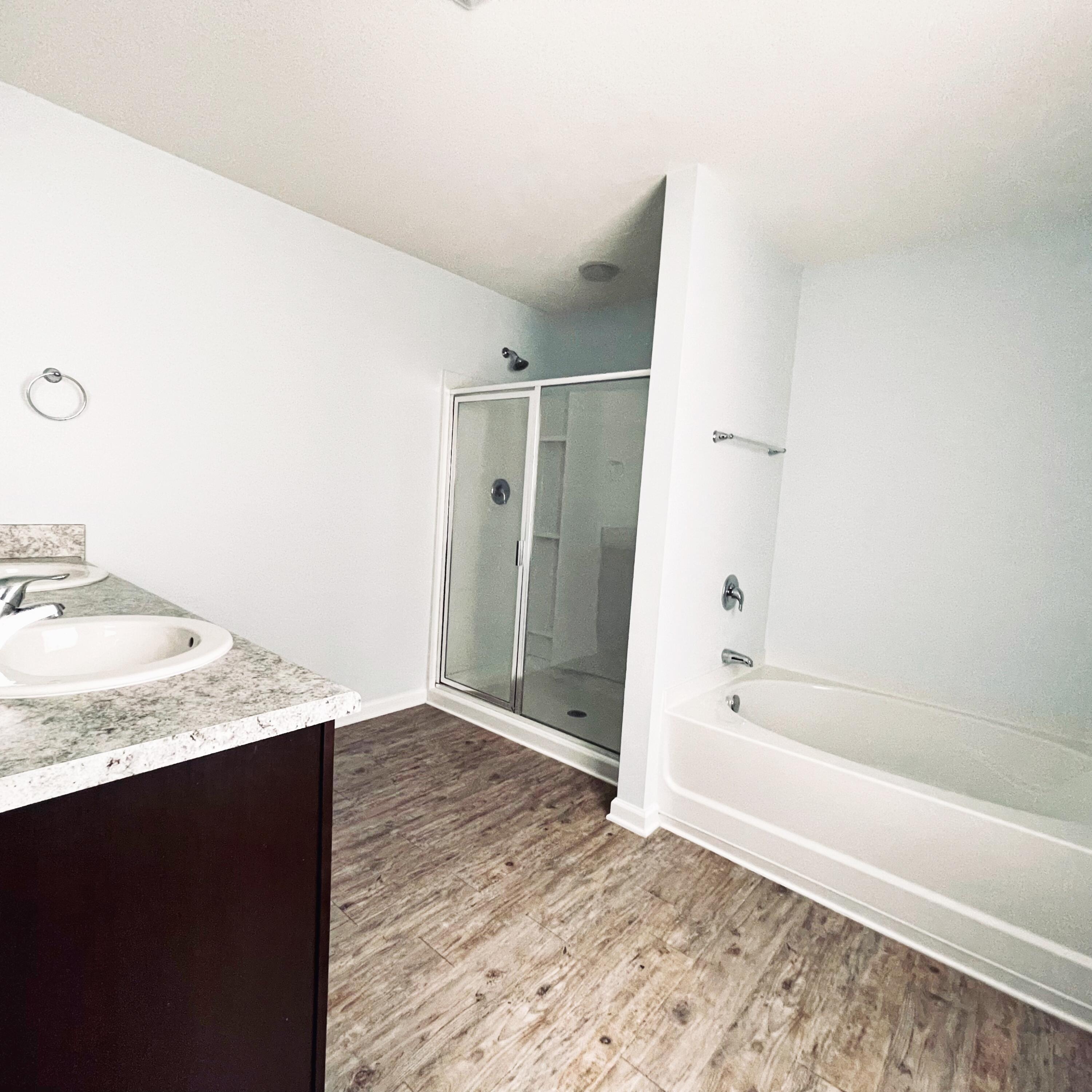 745 Widgeon Way Crestview, FL 32539 - Photo 15 of 17 a bathroom with a granite countertop sink and a bathtub