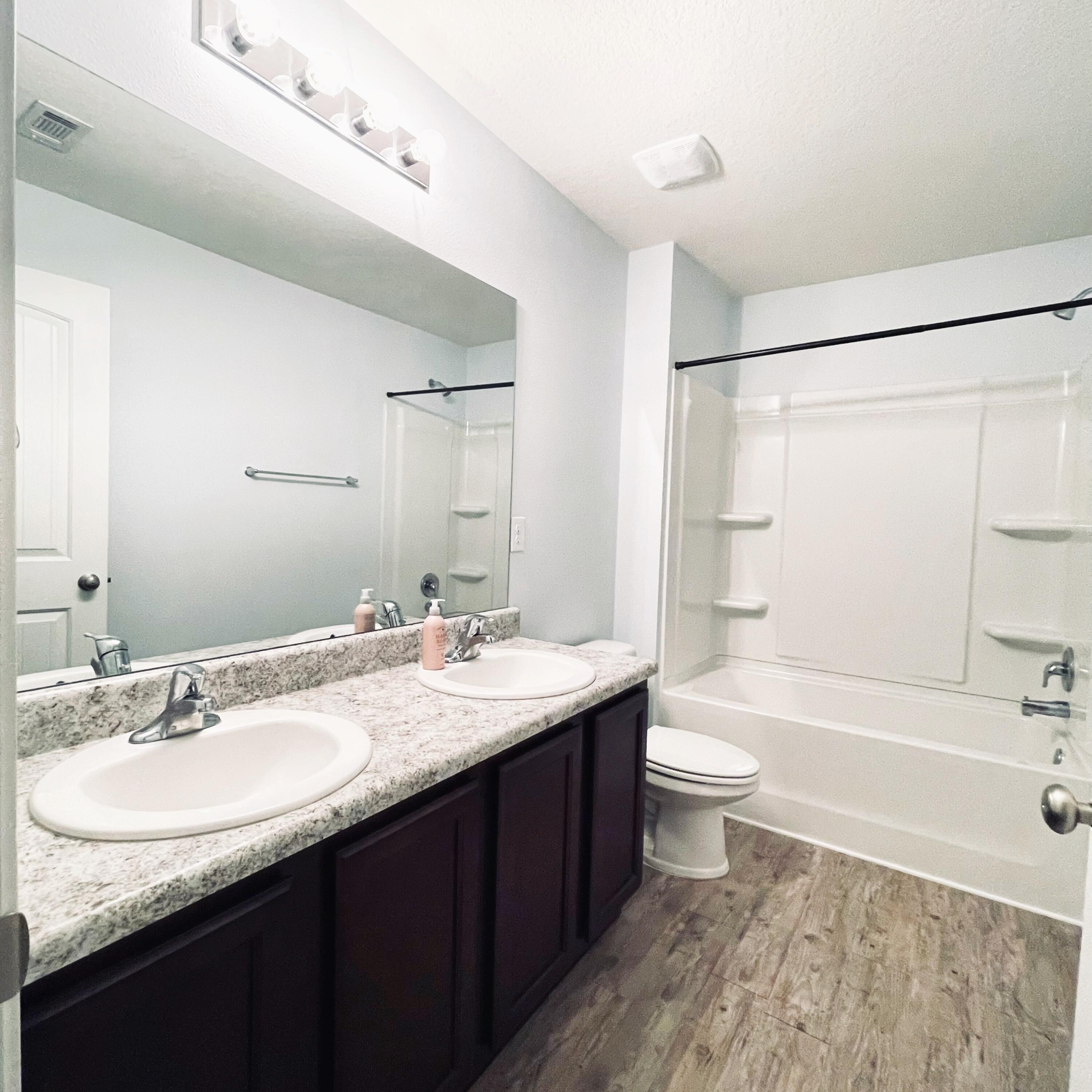 745 Widgeon Way Crestview, FL 32539 - Photo 10 of 17 a bathroom with a granite countertop sink toilet and shower