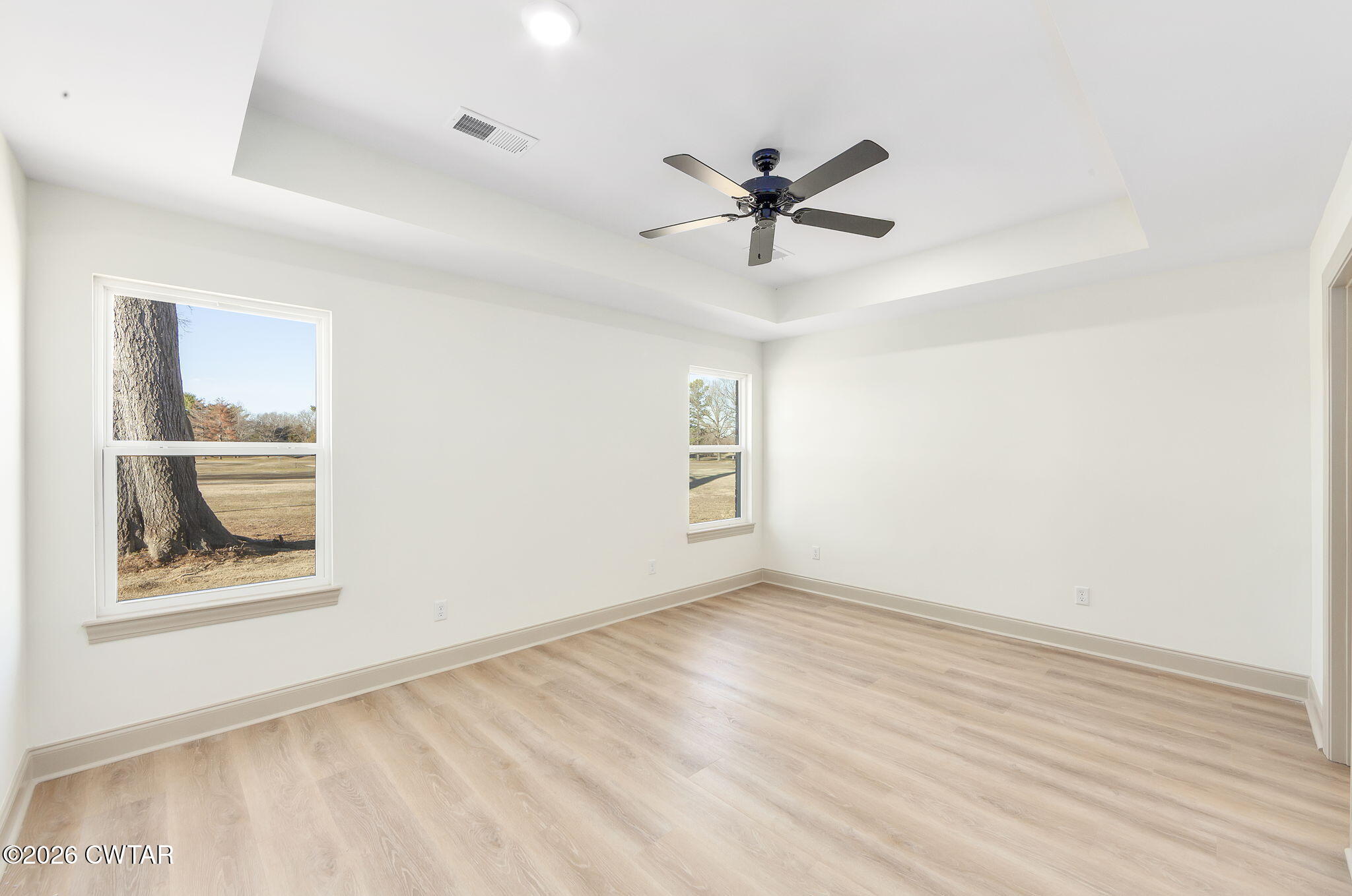 77 Grande Pnes Cove Jackson, TN 38305 - Photo 12 of 31 a view of an empty room with a window and a ceiling fan