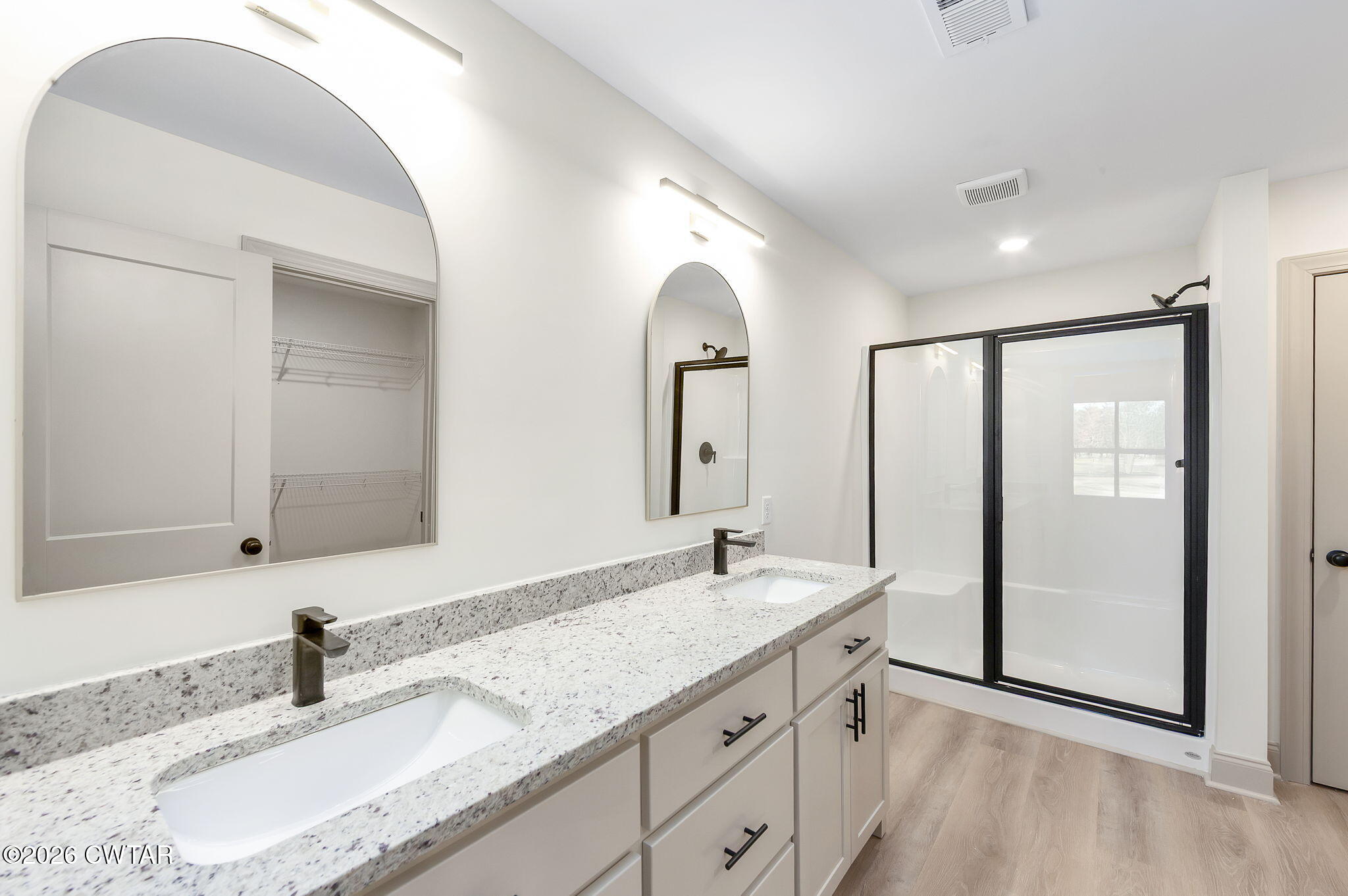 77 Grande Pnes Cove Jackson, TN 38305 - Photo 14 of 31 a bathroom with double vanity sinks and a mirror