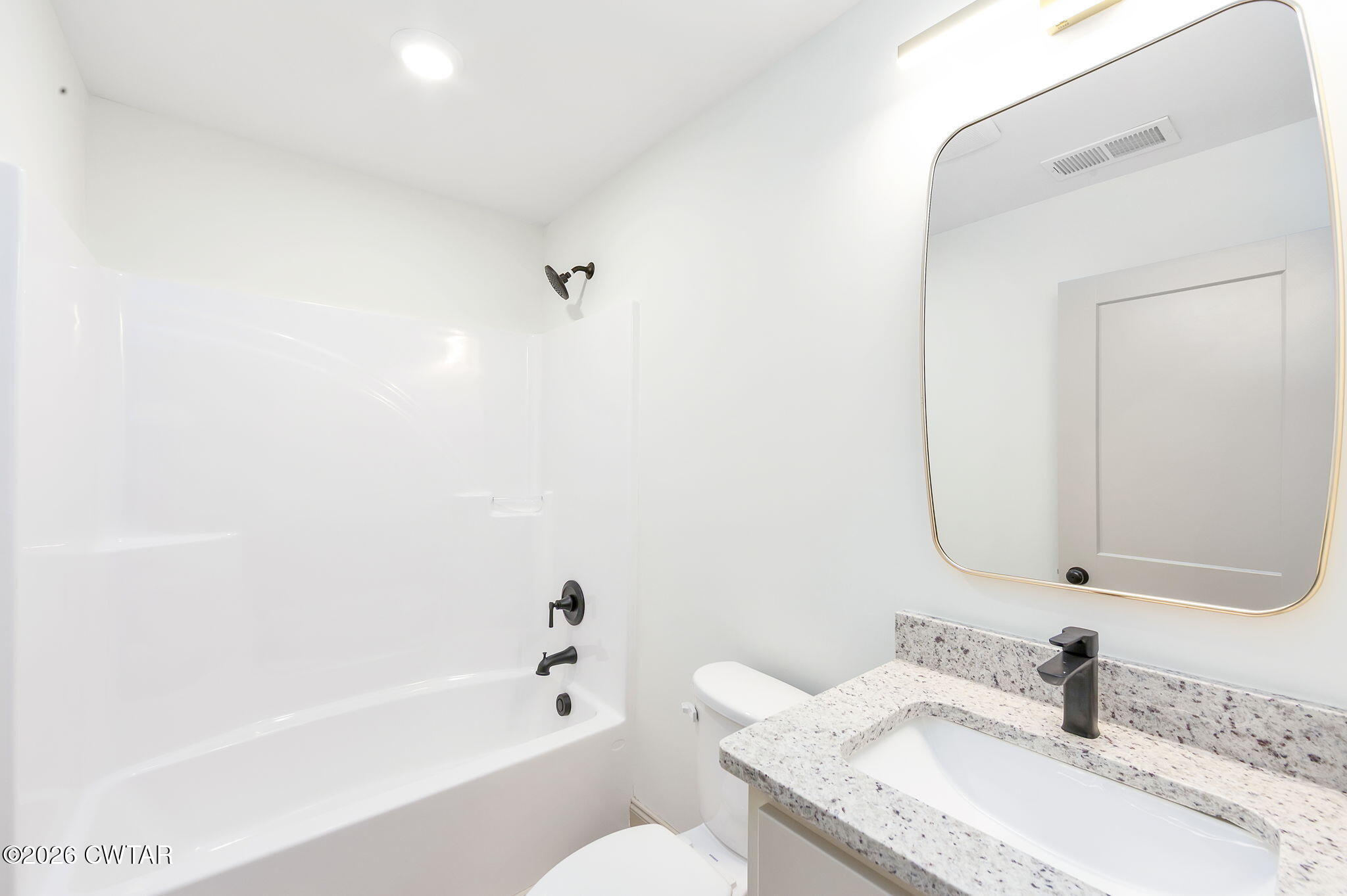 77 Grande Pnes Cove Jackson, TN 38305 - Photo 18 of 31 a bathroom with a granite countertop sink mirror toilet and bathtub