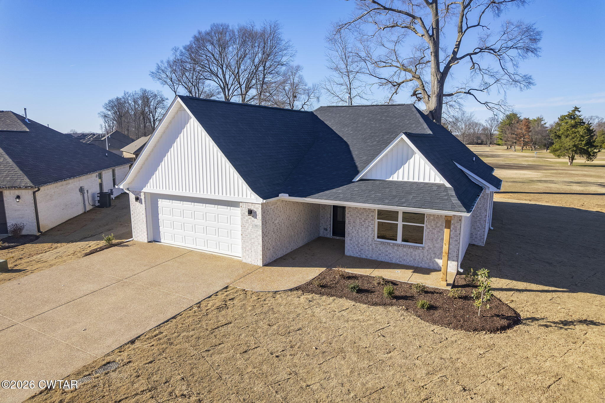 77 Grande Pnes Cove Jackson, TN 38305 - Photo 4 of 31 a front view of a house with a yard