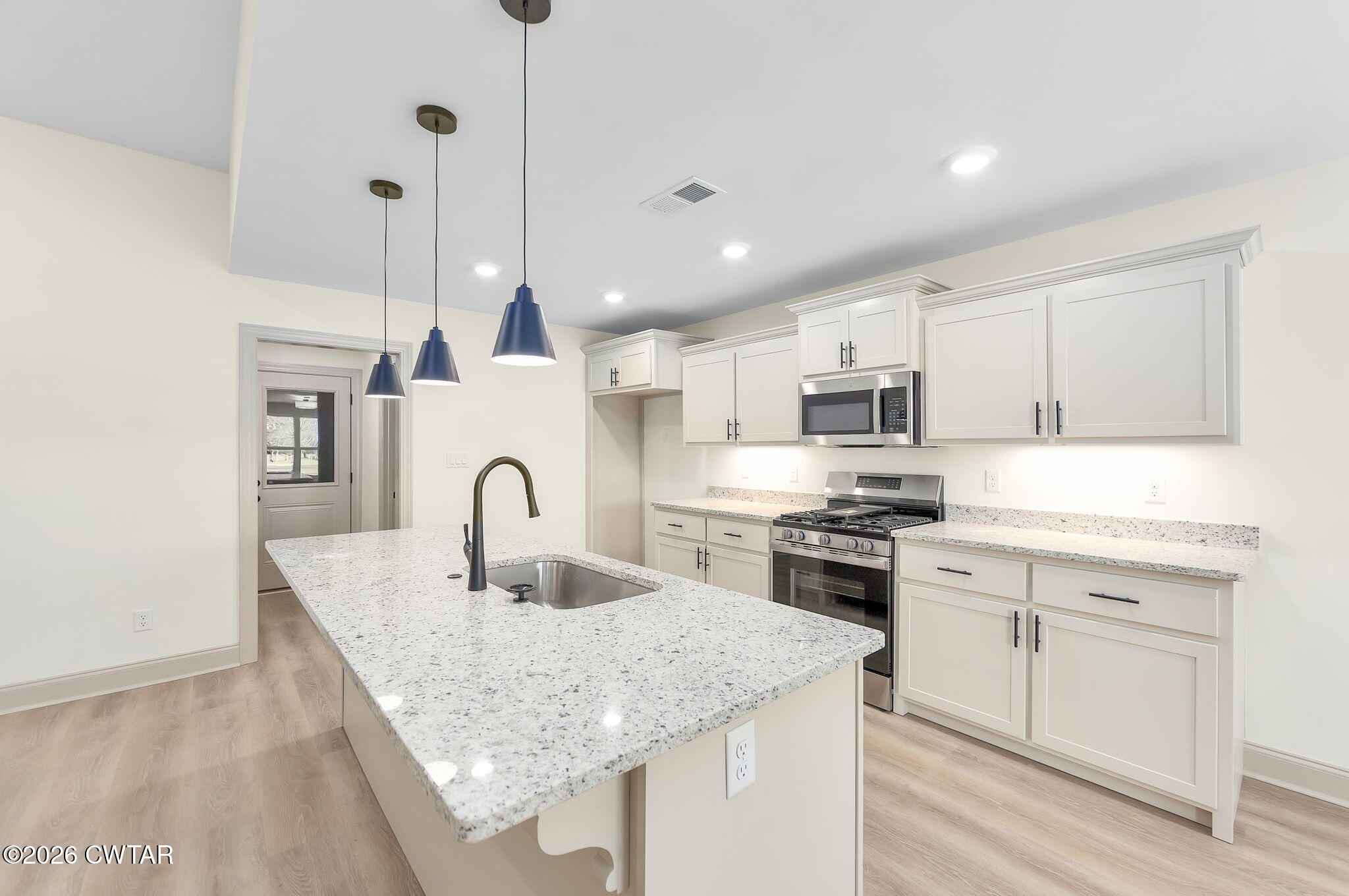 77 Grande Pnes Cove Jackson, TN 38305 - Photo 6 of 31 a kitchen with stainless steel appliances granite countertop a sink a stove and a refrigerator